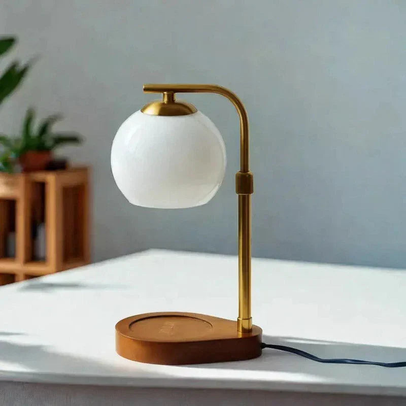 White globe table lamp with a wooden base on a side table